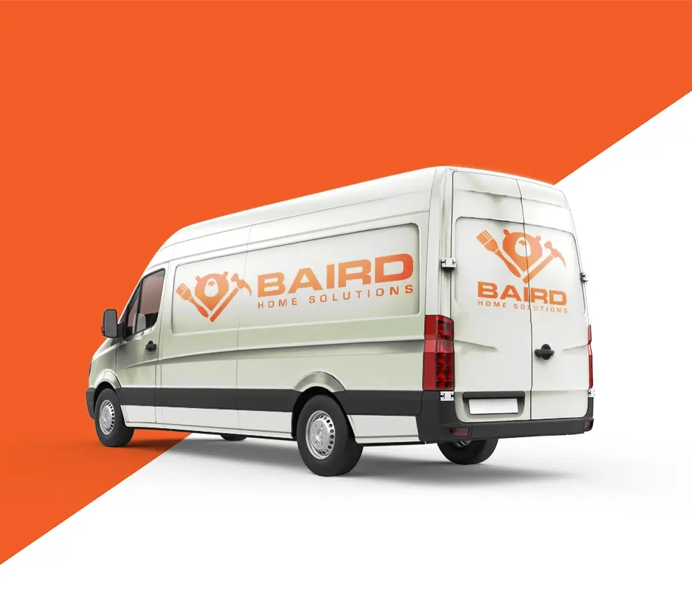 Baird Home Solutions branded decals on the side and back of a van